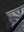 Close-up texture of black waterproof lightweight rain jacket with hood fabric showing water-repellent weave detail.