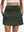 Front lower body shot of model wearing army green women's stretch a-line golf skort with 7 pockets