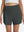 Front lower body shot of model wearing dark grey women's gym golf shorts with liner pocket