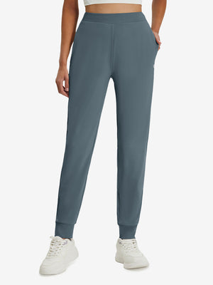 Front lower body shot of model wearing grey blue women's lightweight athletic sweatpants