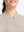 Front shot from nose to chest of model wearing beige white women's q-zip pin striped texture golf shirts