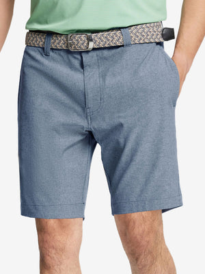 Front view of youth wearing dark blue Heather Performance Golf Shorts, showing fit and style
