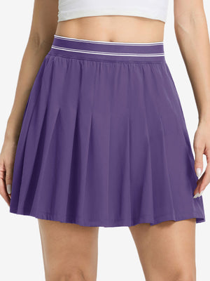 Front lower body shot of model wearing dark purple women's moisture-wicking athletic tennis skirts
