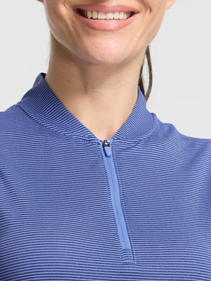 Front shot from nose to chest of model wearing light blue navy women's q-zip pin striped texture golf shirts