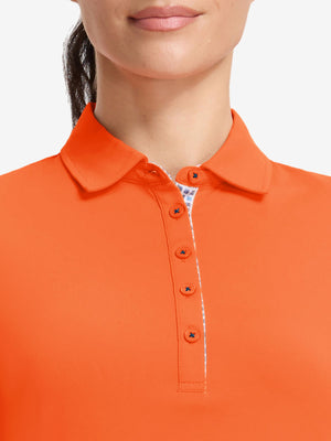 Front shot from nose to chest of model wearing orange women's 5 buttons collared polo shirts