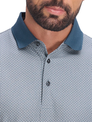 Front shot from nose to chest of model wearing misty blue moisture wicking jacquard golf shirts