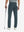 Rear lower-body: model in grey blue stretch quick dry casual golf pants with 4 pockets holding golf club in right hand.