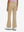 Back lower body shot of model wearing light khaki women's high waist stretch golf pants with pockets