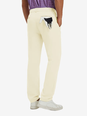 Back view of model wearing water-resistant golf stretch nylon pants, tailored stretch fit in beige.