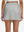 Back lower body shot of model wearing glacier grey high waist built-in short a-line golf skirt with 5 pockets