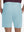 Back lower body shot of model wearing light blue flat front hybrid golf shorts