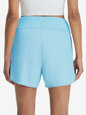 Back lower body shot of model wearing lake green women's gym golf shorts with liner pocket
