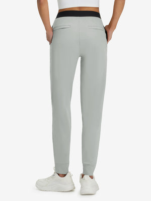Back lower body shot of model wearing silver gray women's lightweight athletic sweatpants