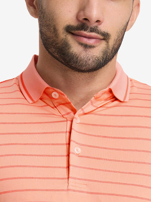 Front shot from nose to chest of model wearing peach amber/calypso coral non-curl ribbed collar striped polo shirts