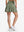 Back lower body shot of model wearing mossy stone women's high waisted golf skirts with 4 inner pockets