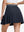Back lower body shot of model wearing navy blue women's moisture-wicking athletic tennis skirts