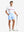 Full-body shot of model holding golf club, styled with Light Blue Quick Dry Casual Shorts.