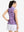 Back upper body shot of model wearing rose red florals women's sleeveless q-zip print quick dry golf tops