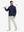 Model holding a golf club, wearing lightweight flat front casual trousers in silver grey, full-body view.