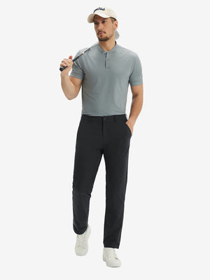 Full front view: model in black stretch quick dry casual golf pants with 4 pockets resting golf club on shoulder.