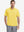 Model half-body front view wearing yellow cotton blend plain shirt.