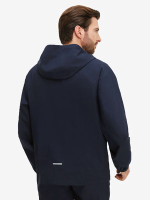 Back upper body shot of model wearing navy waterproof lightweight rain jacket with hood