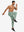 Back lower body view showing beryl green soft sweatpants with 4 zipper pockets