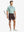 GLACIER GREY 4-way Stretch Performance Solid Shorts, golfer full-body front with club, 7 Inch length