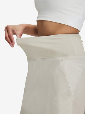 Detail view of elastic waistband on oyster gray women's stretch a-line golf skort with 7 pockets
