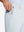 Hand placing an iPhone into pocket of soft lightweight casual golf pants with 5 pockets in misty grey.