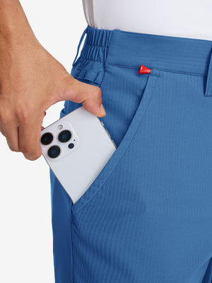 Hand placing an iPhone into pocket of lightweight flat front casual trousers in colony blue.