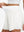 Detail view of elastic waistband on white women's gym golf shorts with liner pocket