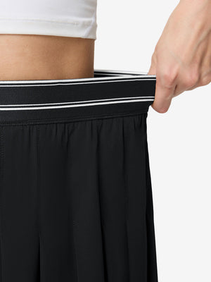Detail view of elastic waistband on black women's moisture-wicking athletic tennis skirts