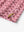 Close-up detail of side slit hem on PINK DONUT polo designed for comfort and movement