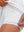 Inner side detail view in white of women's lightweight golf dress with 2 pockets.