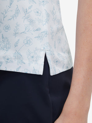 Detail view of hem on white blue florals women's sleeveless v-neck print golf shirts