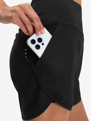 Side view of pocket on black women's high waist 2 in 1 quick dry shorts with 7 pockets