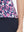 Detail view of hem on rose red florals women's sleeveless v-neck print golf shirts
