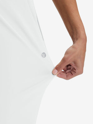 View showing loose fit of white women's high waist stretch golf pants with pockets