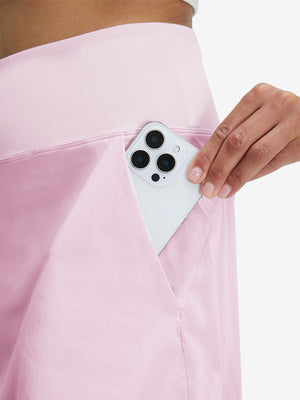 Detail view of side pocket on light pink women's stretch a-line golf skort with 7 pockets