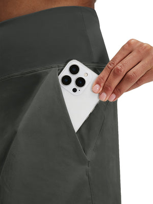 Detail view of side pocket on dark grey women's stretch a-line golf skort with 7 pockets