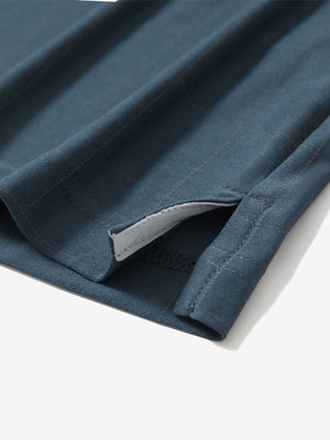 Detail view of hem on dolphin grid performance reflective checked collar golf shirt