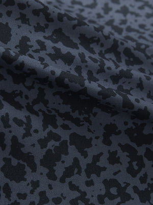 Close-up texture of black gray blocks women's sleeveless v-neck print golf shirts fabric showing printed weave detail.