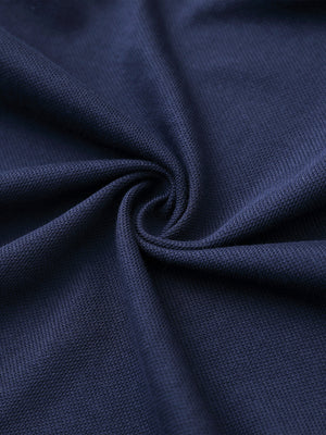 Fabric close-up of navy cotton blend pique plain shirt, breathable pique fabric texture.
