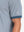 Detail view of hem on misty blue moisture wicking jacquard golf shirts