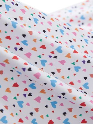 Close-up texture of colorful hearts women's sleeveless v-neck print golf shirts fabric showing printed weave detail.