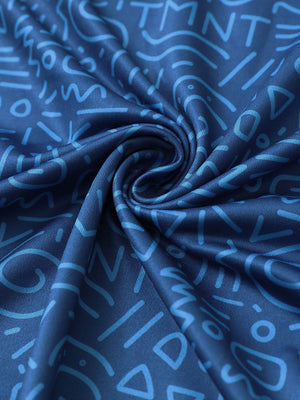 Close-up of blue graffiti performance jersey print polo fabric showing breathable texture and vibrant pattern details.