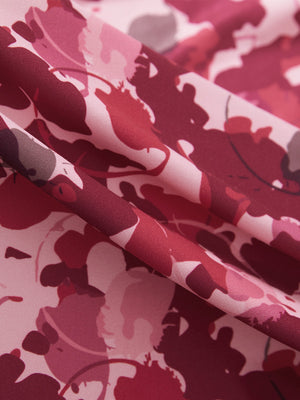 Close-up texture of red splatter women's sleeveless v-neck print golf shirts fabric showing printed weave detail.