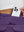 Detail view of back pocket on dark purple women's stretch a-line golf skort with 7 pockets