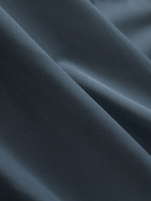 Close-up texture of dark grey cool print plain button up shirts fabric showing detailed print and weave.